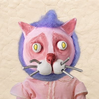 A creepy pink and purple cat-like figurine with yellow eyes and protruding whiskers, wearing a pink dress, appears as the giveaway artwork for a Robinhood Chain NFT drop offering 15 GTD spots for 4,000 handmade mints.

Note: The image itself contains no visible text, numbers, or names—the caption derives its context entirely from the accompanying post.
