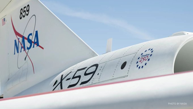 A close-up view of the NASA X-59 aircraft, showing the tail marked with '859' and the NASA logo, along with the aircraft name 'X-59' and a 'Freedom 250' emblem on the fuselage.