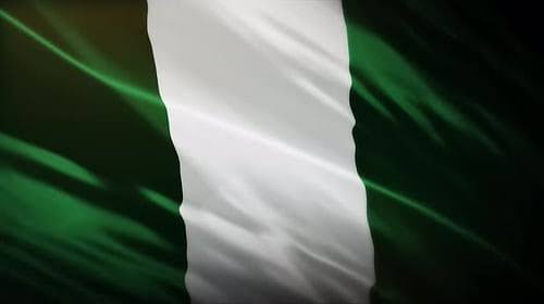 A waving Nigerian flag with its distinctive green-white-green vertical stripes is displayed, symbolizing the national backdrop for the launch of cNGN, Nigeria's first SEC-regulated Naira stablecoin now live on the Celo network.