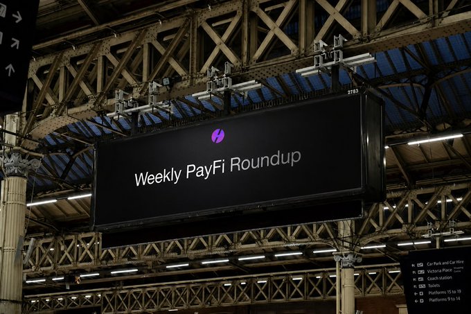 A large hanging digital billboard at a train station displays the text "Weekly PayFi Roundup" with a purple logo. In the background, a partially visible directional sign lists platform locations including "Car Park," "Victoria Place," "Coach station," "Taxi," "Platforms 9 to 18," and "Platforms 9 to 14."