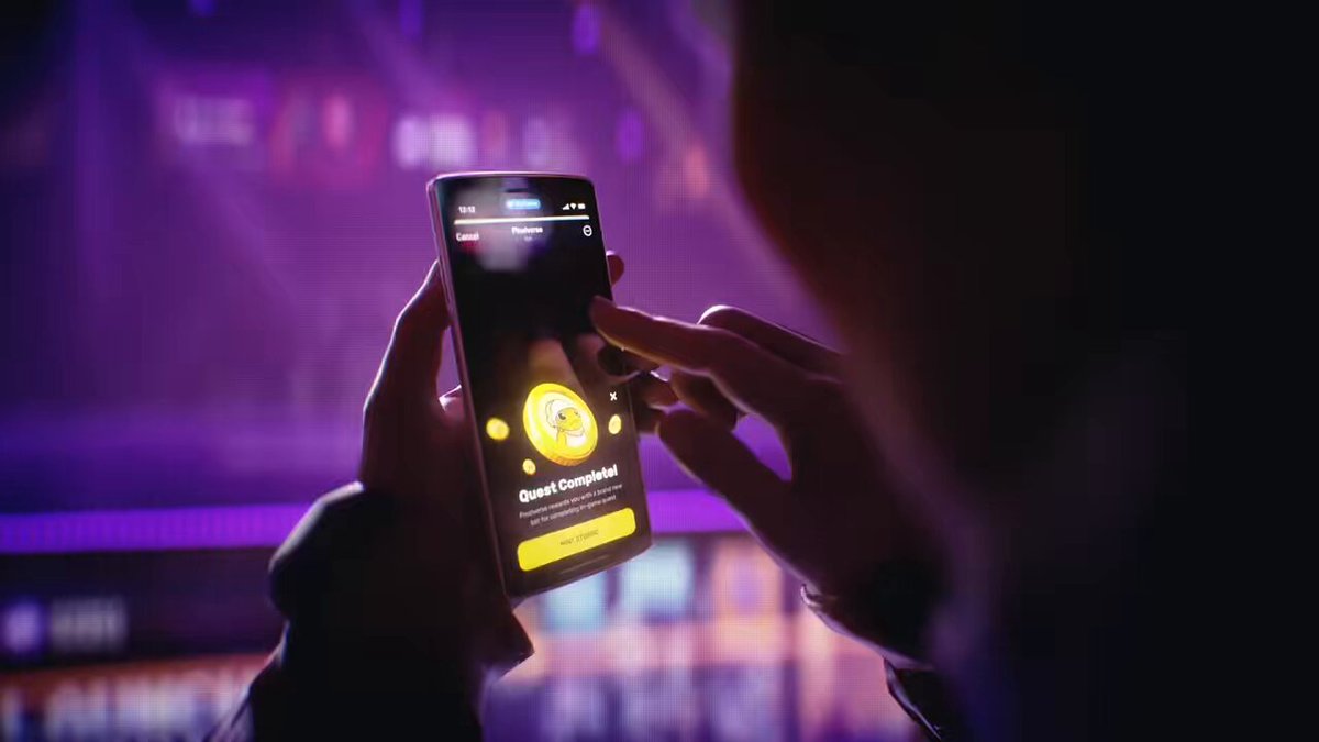 The image shows a person holding up their phone displaying an app called "Open." The background of the photo features a purple screen that appears to be glowing with yellow light. The text on the image reads, "Can'T wait to make beautiful things happen with $TURBO again, BILLION WAS PROGRAMMED". This suggests that the person is excited about using the app and might have received it as a gift or won it in some way.