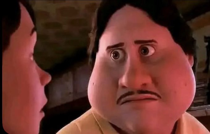 A still from an animated film showing a man with a mustache and wide, surprised eyes looking at another character in profile.