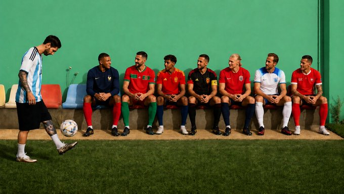 Lionel Messi, wearing the Argentina jersey, juggles a soccer ball while six players in various national team kits (including France, Portugal, and England) sit on a bench watching him. The playful scene of elite footballers choosing sides parallels the post's message about selecting a champion before market shifts occur.