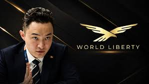A man in a suit stands next to the 'WORLD LIBERTY' logo featuring a stylized eagle.