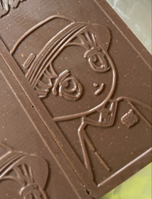 A close-up of a chocolate bar embossed with a stylized woman's portrait, ironically pairing with the post's "weekend runner" joke about hitting the lake while showcasing a contrasting image of a well-dressed, stationary figure.
