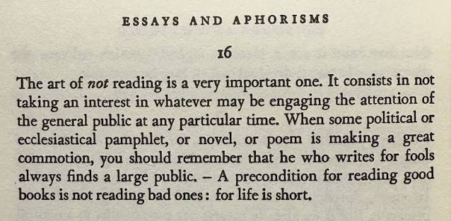 This image shows a page from a book titled "ESSAYS AND APHORISMS" featuring aphorism 16, which begins with the highlighted phrase "The art of not reading is a very important one," advising readers that a precondition for reading good books is not wasting time on bad ones.