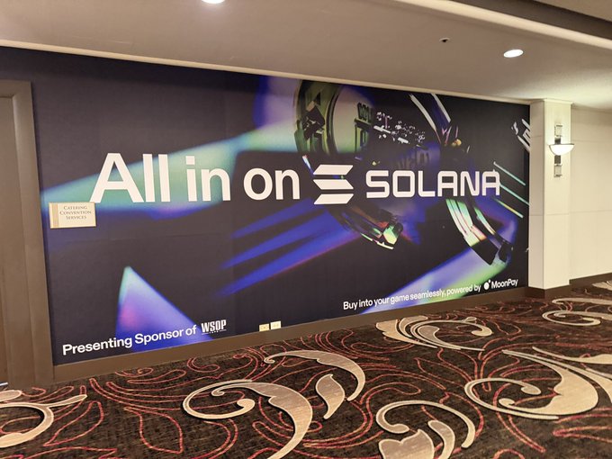 A large illuminated wall advertisement reading 'All in on SOLANA' with 'Presenting Sponsor of WSOP' and 'Buy into your game seamlessly, powered by MoonPay' displayed in what appears to be a hotel or casino corridor.