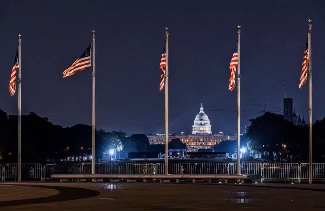 The image shows a group of American flags flying at night, with the United States Capitol building visible in the background. The scene appears to be set in Washington D.C., where Donald Trump has been pushing for the passage of the CLARITY Act. The act aims to regulate cryptocurrencies and other digital assets by requiring exchanges to report transactions to the Securities and Exchange Commission (SEC). The image captures a moment when the clock is ticking, and the urgency of passing the act without delay looms over the nation's financial landscape.