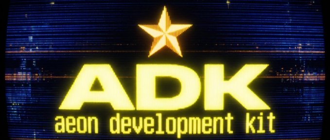 Glowing yellow 'ADK - aeon development kit' logo with a star symbol displayed against a dark blue background.