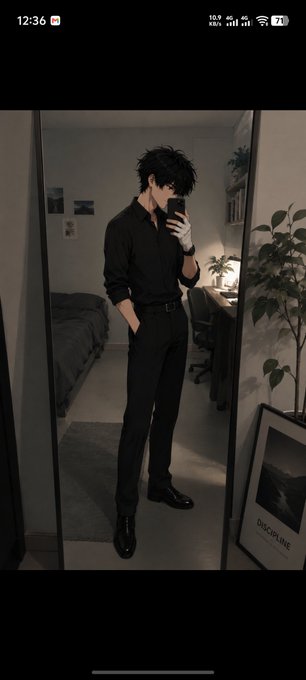 A mirror selfie phone screenshot of an anime-style man with messy black hair wearing an all-black outfit (button-up shirt, trousers, and shoes) in a dimly lit bedroom.
