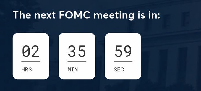 A countdown timer displays "The next FOMC meeting is in: 02 HRS, 35 MIN, 59 SEC," set against a dark blue background with a building facade. The image relates to the post by highlighting the upcoming Federal Reserve FOMC meeting following the announcement of no changes in interest rates, a key event for crypto and financial markets.