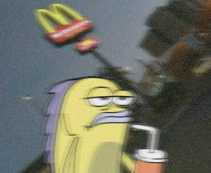 A blurry, distorted image of a cartoon fish character holding a McDonald's cup with straw, with the McDonald's golden arches logo glowing in the background.