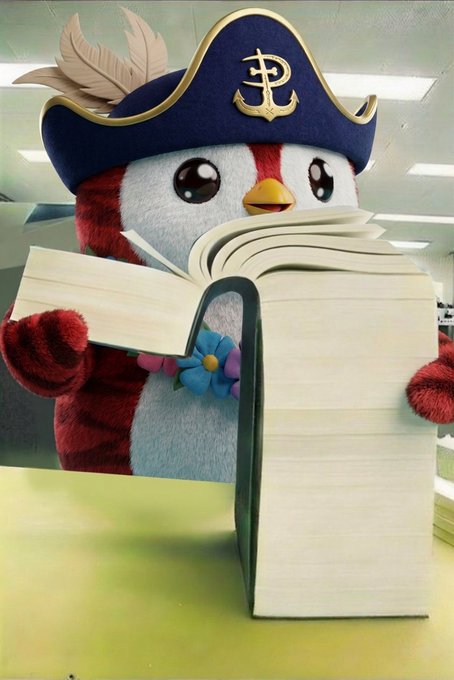 A plush penguin mascot wearing a pirate hat with an anchor symbol stands behind an open book on a table.