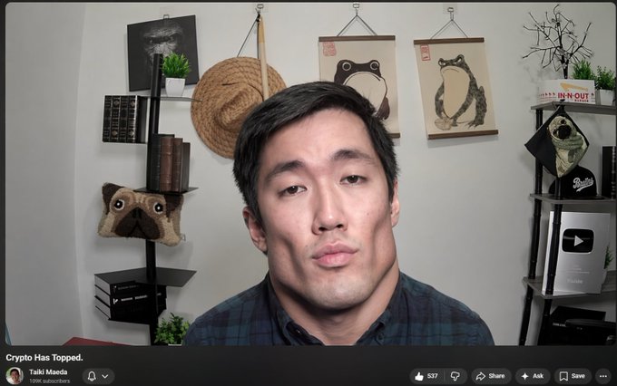 A man in a blue plaid shirt appears in a YouTube video thumbnail titled 'Crypto Has Topped.' by Taiki Maeda, with Japanese-style decor including tanuki scrolls behind him.