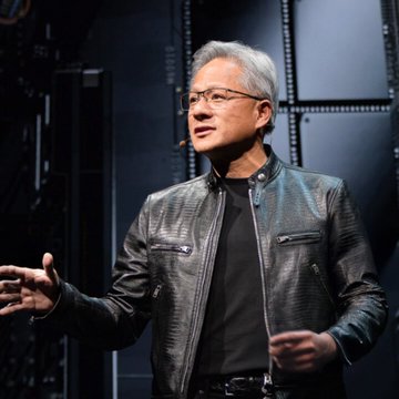 Jensen Huang, CEO of NVIDIA, wearing his signature black leather jacket and glasses, appears to be presenting on stage.