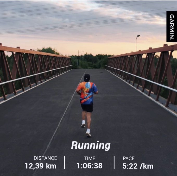 A runner in a colorful shirt crosses a bridge at dawn, captured in a Garmin post showing a 12.39 km run completed in 1:06:38 at a 5:22 /km pace—perfectly matching the "keep moving" spirit of starting the day with a run.