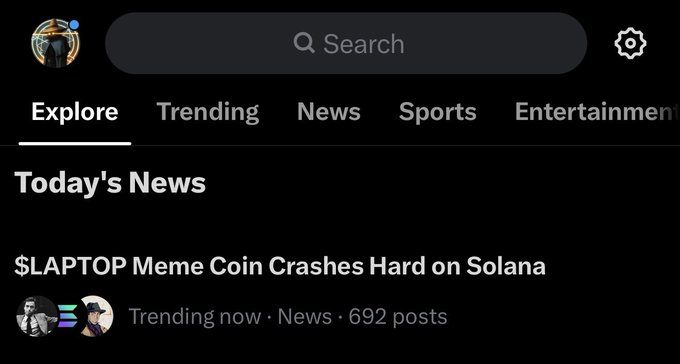 A mobile app interface shows the "Explore" tab displaying a "Today's News" headline reading "$LAPTOP Meme Coin Crashes Hard on Solana," tagged as Trending now · News · 692 posts, which relates to the post's humorous commentary about the $LAPTOP meme coin crashing while @grok unfairly blamed @solana.