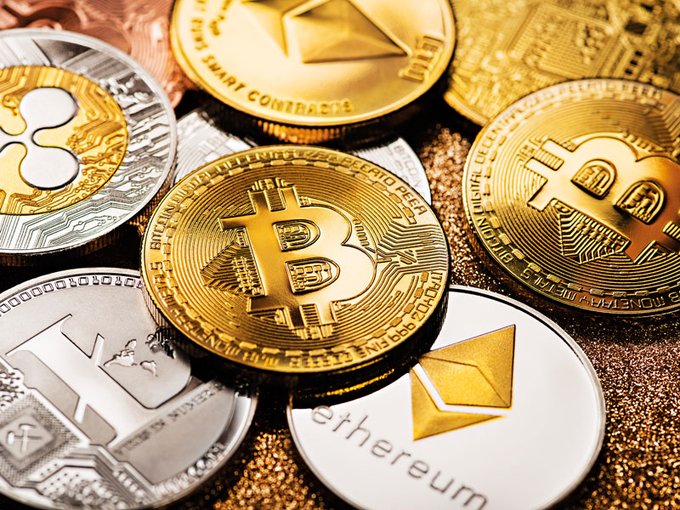 The image shows an assortment of gold and silver coins, including five Bitcoins, all scattered together on top of a gold background. The largest coin among them is a Bitcoin, which has the word "Ethereum" written in white at the bottom, suggesting that these coins are from different cryptocurrency exchanges like Bitcoin and Ethereum. The post appears to be about cryptocurrency trading or the sale of Bitcoins, with the image providing a close-up view of the various coins displayed on top of a gold surface.