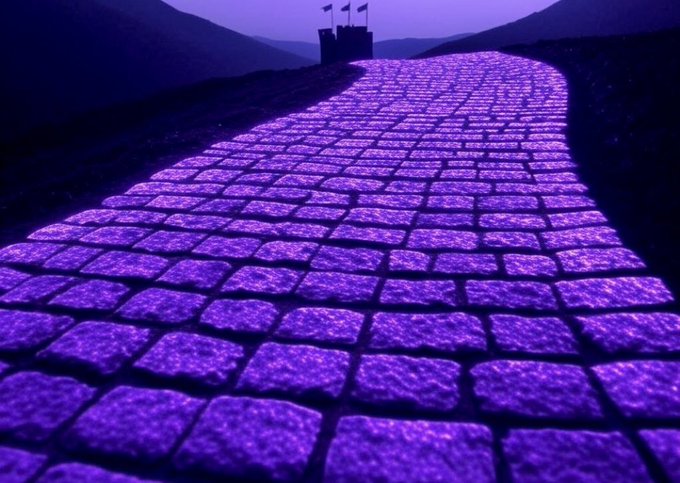 A glowing purple brick road stretches toward a distant castle beneath a dusky sky, visually echoing the post's "Purple Brick Road" reference and symbolizing the path toward XPR Network and the $PBR token on SimpleDEX.