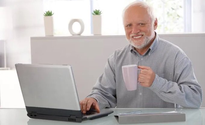 A cheerful older gentleman smiles while holding a pink mug at his laptop, having just logged in to confirm his Bitcoin wallet is safe with Fidelity. The image conveys relief and satisfaction, matching the post's reassurance that his crypto assets are still secure after contacting Fidelity's support team.