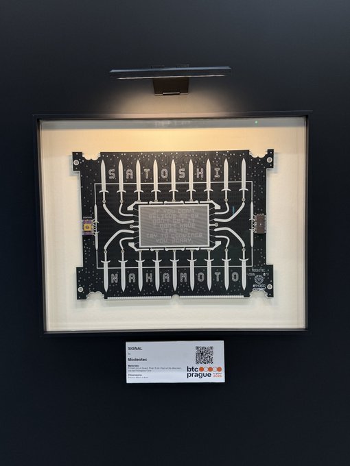 The image features a black frame with a white square panel inside, which appears to be an electronic device or circuit board. There are multiple small squares within this larger panel, possibly representing different components of the device. The background of the image is dark, making the white square stand out prominently. In the bottom right corner of the image, there's a post that reads "Follow the Signal." This suggests that the image might be related to some sort of electronic or technological theme, and the focus on the white square panel could be an intentional artistic choice or a symbolic representation of the device's inner workings.