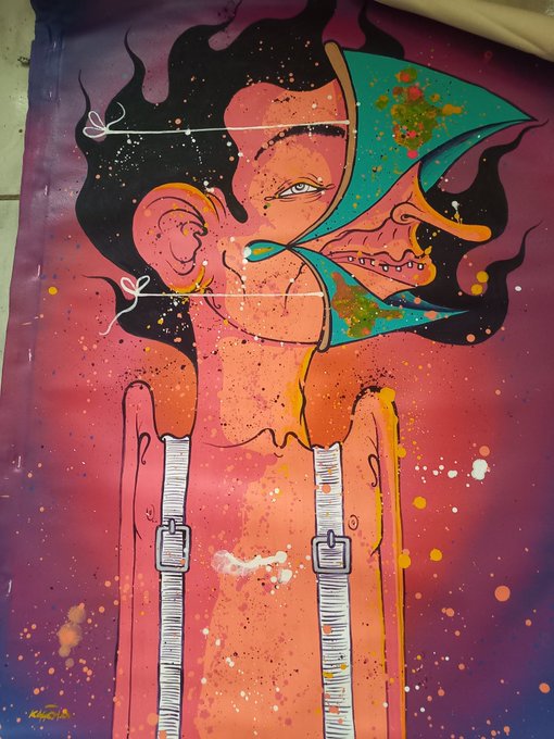 A vibrant street art poster depicts a stylized figure with flowing black hair, orange skin, and a teal face covering, with paint splatter effects in pink, yellow, and purple.