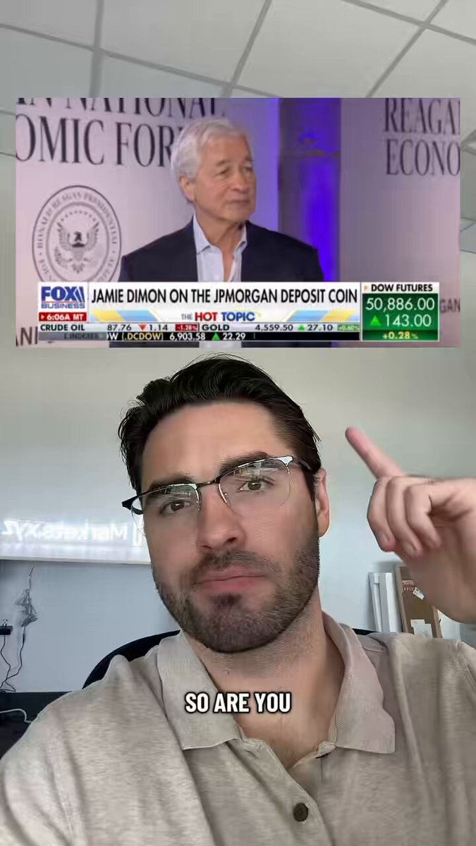 The image shows a man wearing glasses, with his finger pointing at an image of a man giving a speech or appearing on TV. The caption below the image reads "BREAKING: CEO of JP Morgan furious over clarity act and calls the CEO of Coinbase a 'piece of shit' Brenton Wood's $xrp $xlm $hype". This suggests that there is some sort of disagreement or conflict between two individuals, possibly related to an issue in the financial world.