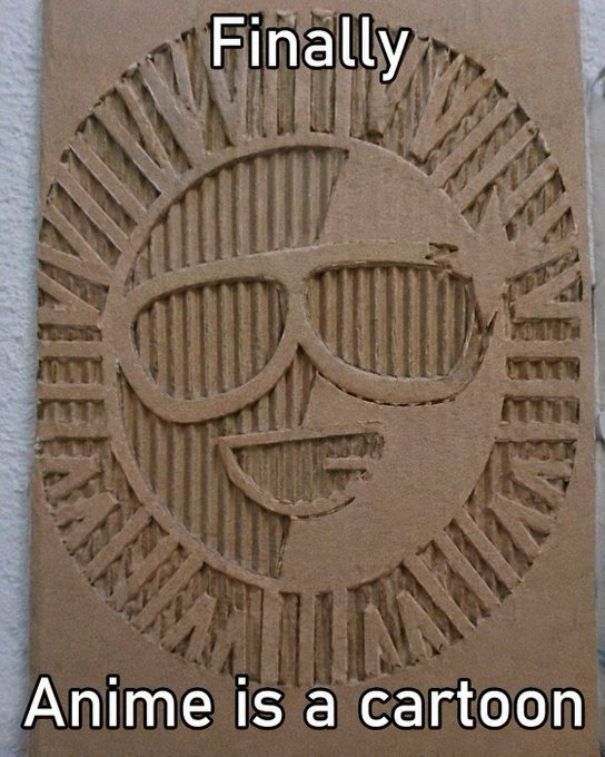 The image shows an intricately carved cardboard piece featuring a smiling sun wearing sunglasses, with the text "Finally" at the top and "Anime is a cartoon" at the bottom. This relates to the post's message by demonstrating how creative craftsmanship can transform a simple, humble material like cardboard into an impressive "masterpiece," while also sharing a humorous take on the long-running debate about anime's classification.