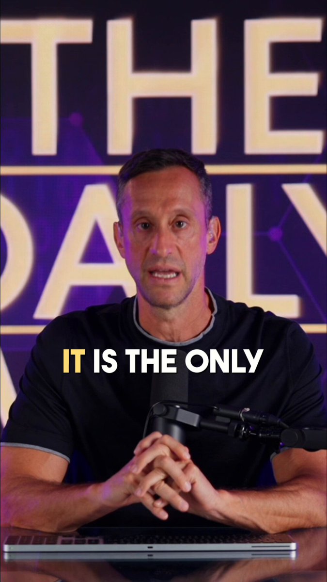 The image features a man sitting at a desk with his hands crossed, wearing a black shirt. Behind him, there's a purple background that says "It Is The Only" written in yellow letters. The text appears to be related to Bitcoin or cryptocurrency, as suggested by the caption provided.