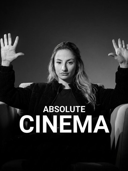A black and white photo of a young woman holding her hands up with the text "ABSOLUTE CINEMA" overlaid across her chest.