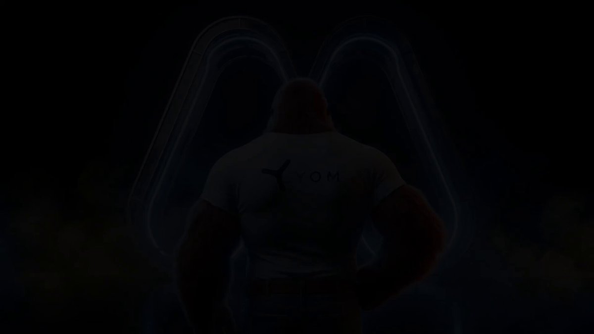 The image features a muscular man with a white t-shirt that says "YOM MEXC" written across his back. The background of the image is dark, which contrasts with the bright white text on the man's shirt. The image also contains some text that reads "YOM MEXC $YOM is now live on @Alpha_MEXC".