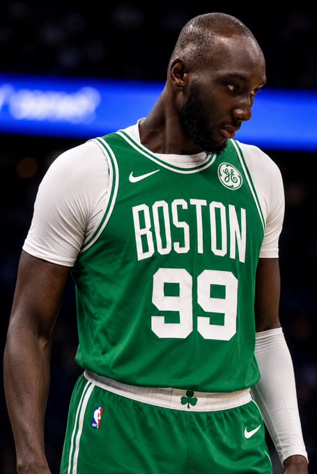 Boston Celtics player #99, Tacko Fall, is shown looking downward during a game, wearing his green and white jersey. The image relates to the post's claim of him joining LeBron James and the Sixers, though he is pictured in his Celtics uniform rather than a Philadelphia one.