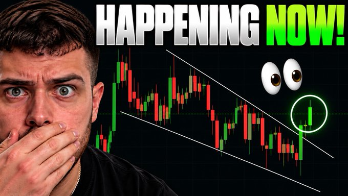 A YouTube thumbnail featuring a man with a shocked expression, his hand covering his mouth, alongside the bold text "HAPPENING NOW!" and a Bitcoin candlestick chart showing price action within a descending wedge pattern, with a circled candle indicating a potential breakout—aligning with the post's announcement of a significant Bitcoin price movement.