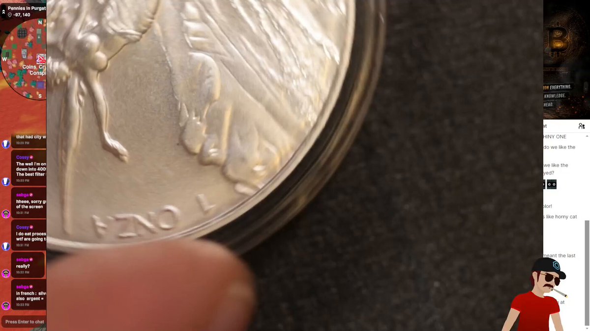 The image features a close-up of a silver coin with the words "Libertad" written on it, which translates to "freedom." The coin is placed on a gray surface against a black background. In the bottom right corner of the image, there's a person wearing a red shirt and sunglasses, possibly watching or discussing the post.