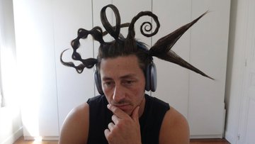 A man wearing headphones and a chaotic tangle of black cables/wires on his head sits with his hand on his chin, looking thoughtful or perplexed. The image humorously visualizes the "incredible things happening" in the Pyth Discord, suggesting overwhelming or tangled activity/communication in the community.