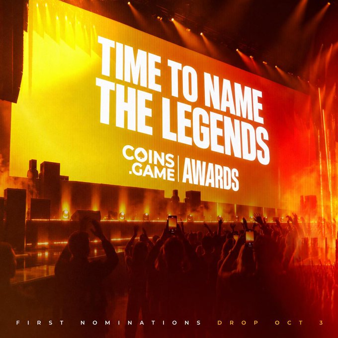 A promotional image for 'COINS .GAME | AWARDS' showing a stage with a large screen displaying 'TIME TO NAME THE LEGENDS' and 'FIRST NOMINATIONS DROP OCT 3' with a crowd holding up phones in front.