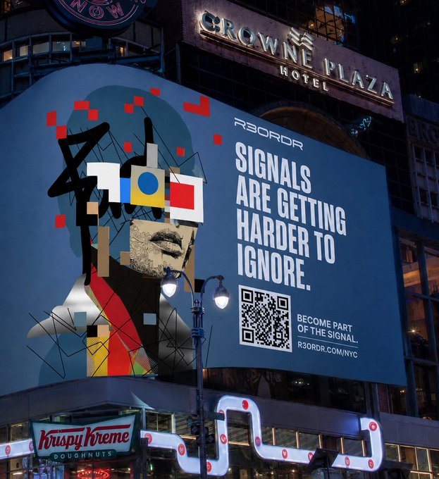 A large digital billboard on the Crowne Plaza Hotel building displays 'R3DR SIGNAL ARE GETTING HARDER TO IGNORE. BECOME PART OF THE SIGNAL. R3DRDR.COM/NYC' along with a QR code and abstract artwork, above a Krispy Kreme storefront at night.