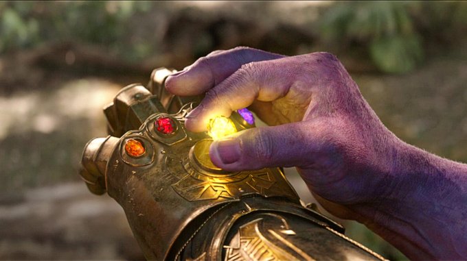 The image shows Thanos from Avengers: 0 War snapping the Infinity Gauntlet to erase half of all life, mirroring Monad's quest to gather essential blockchain "infinity stones" like post-quantum accounts and MEV resistance, suggesting their goal is to reshape the crypto landscape with a decisive snap.