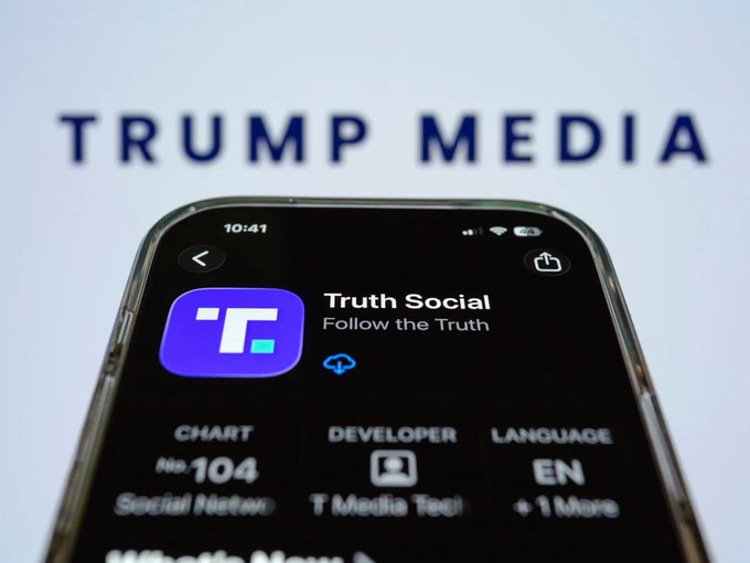 A smartphone displays the "Truth Social - Follow the Truth" app store page in front of a blurred background showing the "TRUMP MEDIA" logo.