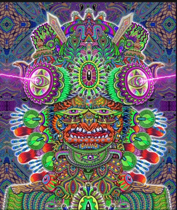 A vibrant, symmetrical psychedelic digital artwork featuring an elaborate deity-like face with multiple eyes, ornate headdress elements, and kaleidoscopic patterns in bright greens, pinks, and purples.