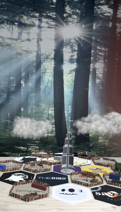 A surreal collage featuring a misty sunlit forest above miniature convention booths, with visible text including "THE 8102" and "Coming soon."