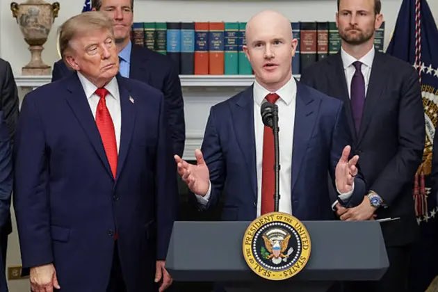 Coinbase CEO Brian Armstrong speaks at a podium with the Presidential Seal, while Donald Trump stands beside him, relating to the post "base got the grok coin" by highlighting a figure often associated with "base" and cryptocurrency.