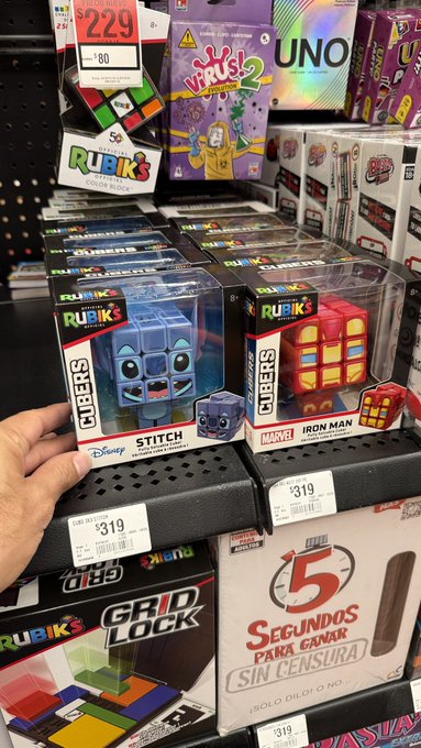 This image shows Rubik's Cubers featuring Stitch and Iron Man, priced at $319, alongside other games like UNO and Virus! Evolution. The post "Exactly. Don't use this as dice" directly relates as these are not dice but puzzles.