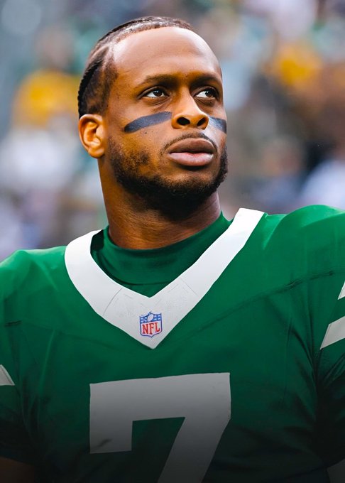 A close-up portrait of a football player wearing a green jersey with the number 7 and eye black under his eyes, with an NFL logo visible on the collar.