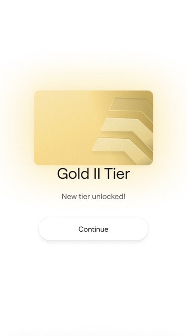 A digital notification screen announces a "Gold II Tier" achievement with the message "New tier unlocked!" above a "Continue" button.