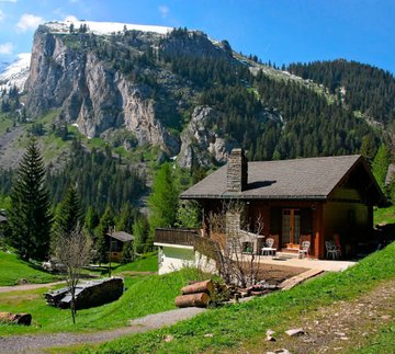 This image of a picturesque mountain chalet visually represents the "house" that can be purchased using Bitcoin as collateral, as described in the accompanying post about leveraging crypto for real estate without selling it.