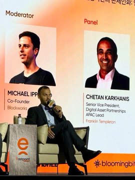 The image shows a man seated on stage at what appears to be a Bloomberg-hosted event, with a large backdrop displaying his profile as a panelist alongside the moderator. The backdrop identifies the panelist as "CHETAN KARKHANIS, Senior Vice President, Digital Asset Partnerships, APAC Lead, Franklin Templeton," suggesting his appearance relates to discussions around tokenizing traditional assets, as referenced in the accompanying post about bringing real-world assets onchain.