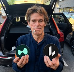 A man stands in front of an open car trunk holding two circular tokens—one featuring a green "L" for Lighter ($LIT) and the other displaying the Hyperliquid ($HYPE) logo. The image visually compares the two competing perpetual DEXs as the post debates Hyperliquid's dominance potentially suffocating Lighter into irrelevance.