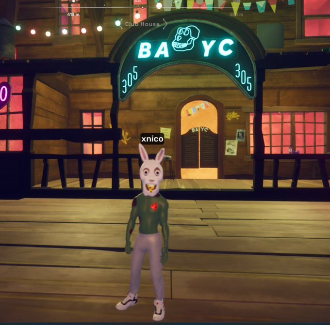A screenshot from a 3D virtual environment, possibly Decentraland, showing a green-skinned avatar with a white rabbit head wearing a gold tooth, standing in front of a wooden building labeled 'BAYC 305' with a 'Club House' sign.