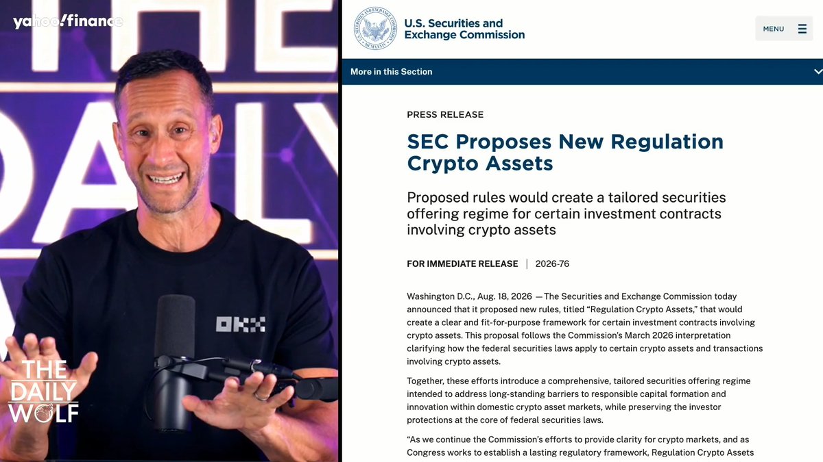 A man wearing a black "OKX" shirt speaks into a microphone on a Yahoo Finance segment titled "The Daily Wolf," with an SEC press release beside him announcing the agency's proposed "Regulation Crypto Assets" framework dated August 18, 2026 (Release 2026-76), which would create a tailored securities offering regime for certain crypto asset investment contracts.